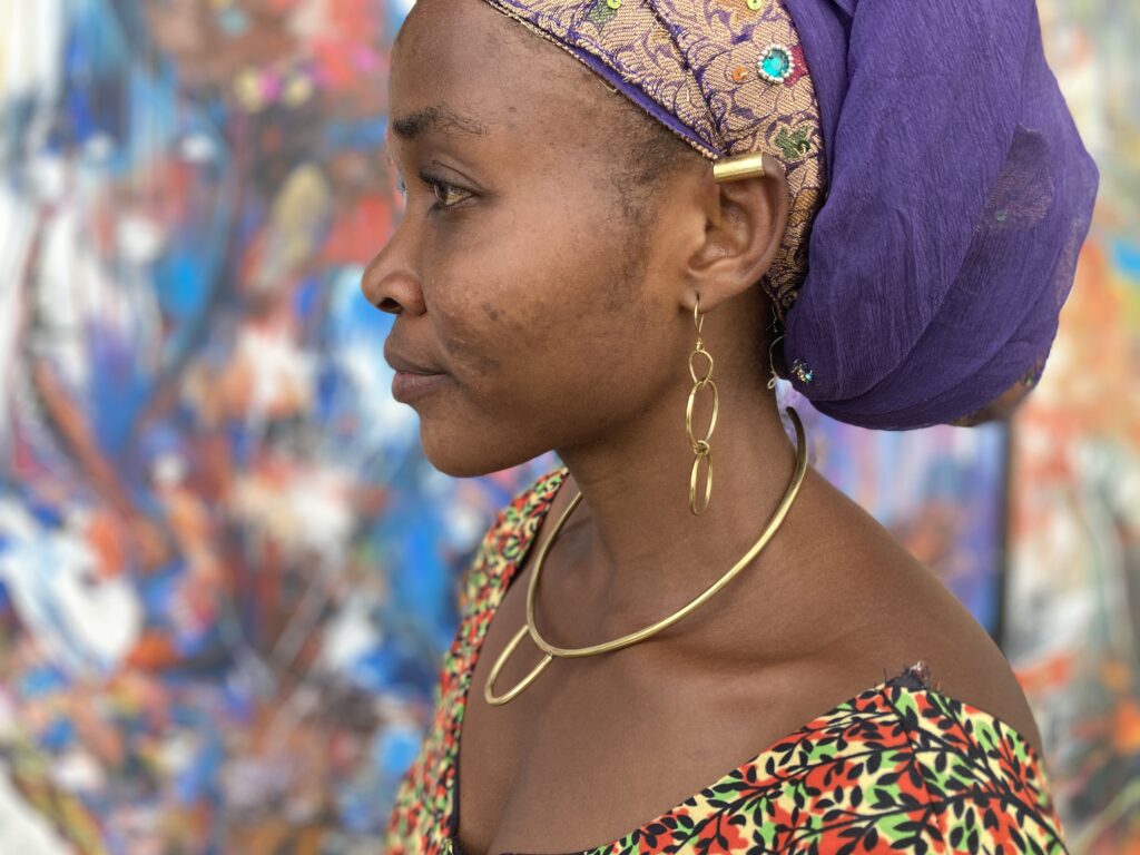 woman wearing brass double hoop earrings, brass ear cuff, brass necklace