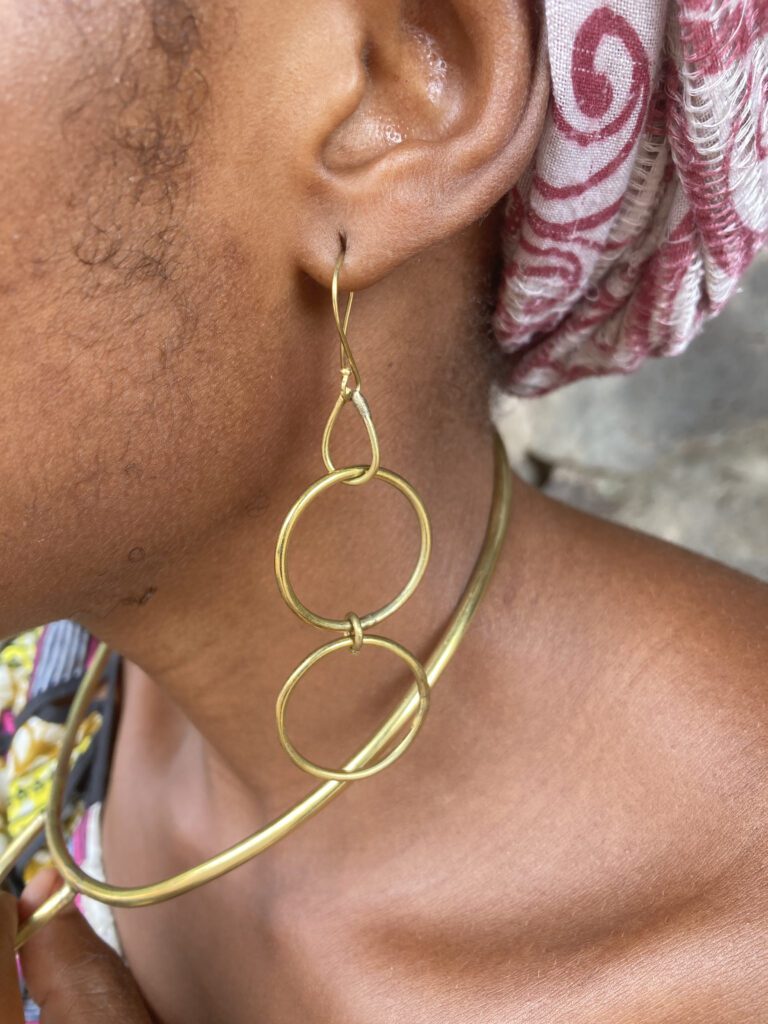 woman wearing double loop brass earrings